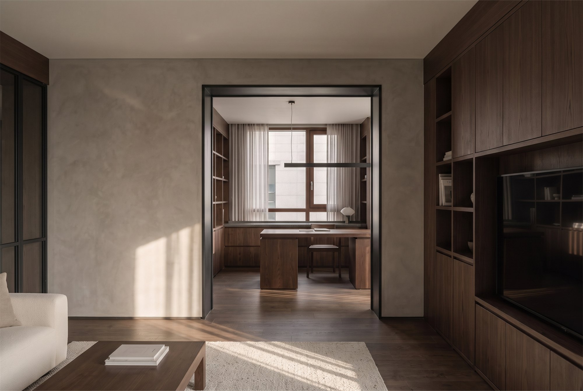QUIET FRAME — dark oak living space with a charcoal metal framed opening to the dining area