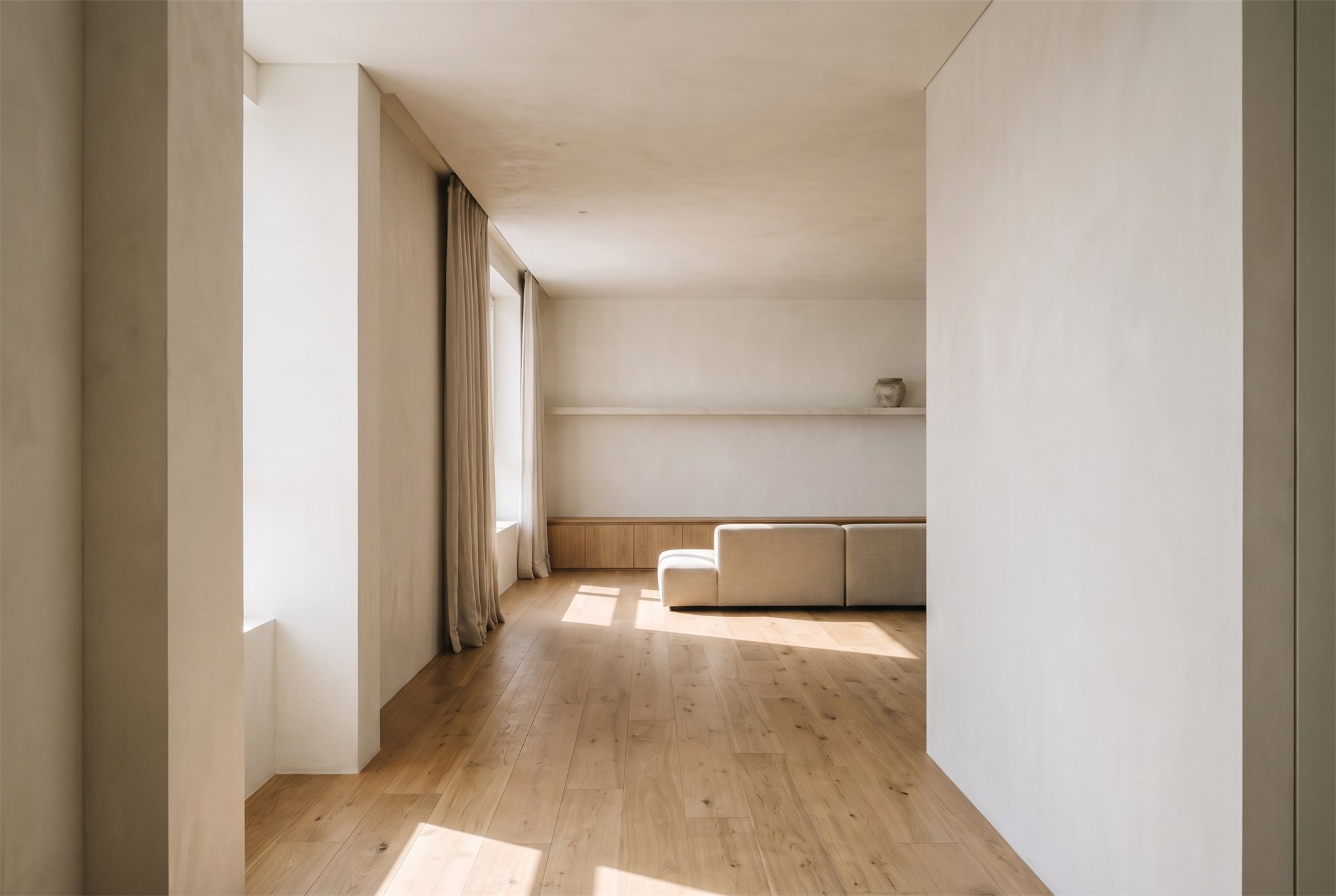 SOFT LIGHT — living room seen from the hallway, morning light across an oak floor